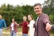 © New Africa - Team building. Group of happy people holding hands outdoors, selective focus