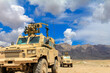 © Boris - Military Vehicles on Patrol in a Desert Terrain for Security Operations