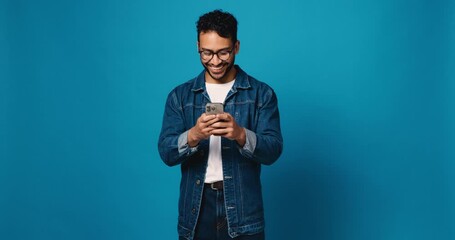 typing, phone and glasses with man in studio for social media, text message and communication. conne
