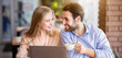 © Prostock-studio - Beautiful Caucasian lady and her boyfriend drinking coffee and watching romantic movie on laptop at cafe. Happy millennial couple with modern gadget spending time together at cozy restaurant, panorama