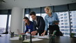 © stockbusters - Office team working paperwork at table conference room. Professional teammates