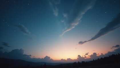 Wall Mural - serene sunset over mountains with stars and clouds