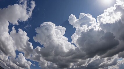 Wall Mural - 4K aerial perspective moving toward a towering wall of cumulus clouds glowing with sunlight as a storm begins to form capturing the power and beauty of nature’s sky in motion