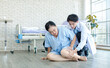 © Bangkok Click Studio - Asian doctor helps assistant offer urgent elderly female patient accident injury falling on ground in hospital floor, woman emergency healthcare with caregiver appears pain support healthcare medical.