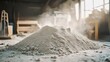 © sukrisna - A large pile of light-gray powder, possibly sawdust or plaster, sits in a workshop.  Smoke or dust motes rise from the top.  Blurred background shows tools and other materials