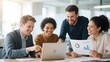 © Big - Four professionals collaborating on a project, discussing data charts and using a laptop in an office setting.