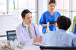 © Bangkok Click Studio - Asian male doctor consulting explain medications to senior female patient assisted by caregiver and nurse professional support trust healthcare checkup, insurance treatment wellness in hospital clinic