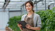 © abc123man - Young Female Agriculturist in Greenhouse Holding Digital Tablet, Modern Farming Technology, Sustainable Agriculture, Crop Management