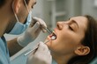 © Irene Kulinchyk - Dentist examining patients teeth with dental instruments in modern clinic, close-up of dental check-up.