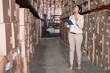 © WavebreakMediaMicro - African American and Asian woman standing in warehouse scanning shelves with tablet, copy space