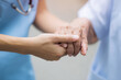 © DaniLana - Nurse and senior patient hands showing empathy and care