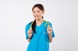 © sorapop - Friendly asian woman portrait, medical nurse, stethoscope holding yellow clinic tools smiles brightly, the kind doctor with scrubs smiles a good nurse looks toward camera, isolated white background