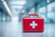 © Promptalo - A red first aid kit with a white cross sits on a smooth surface in a bright, modern hallway, symbolizing emergency medical assistance
