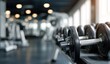 © Marewa - Gym dumbbells in focus, blurred equipment