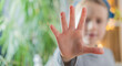 © kittyfly - Young Child, girl raising hand in 'stop' gesture, Kid shows open palm close-up, face out of focus. Blurred face, palm in focus. Concept of rejection, defense, personal boundaries