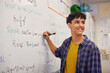 © Rido - Teen high school student solving equation on whiteboard