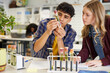 © Rido - Multiethnic student checking and examining science experiment with plant
