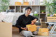 © itchaznong - Unboxing. Young man excitedly opening delivery boxes at home.