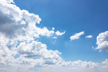 Wall Mural - white fluffy clouds on the azure blue sky. cumulus cloudscape in bright light in summer. weather background for vacation on a sunny day. cloudy atmosphere brings fresh air concept