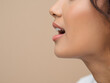 © alfredo - Captivating close-up profile of a woman's mouth speaking with clear white teeth and subtle lip gloss, conveying communication and expression