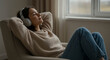 © Elbrandan - Woman Relaxing with Headphones, Listening to Music Indoors.