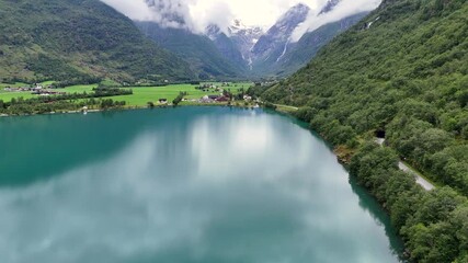 Wall Mural - aerial view of calm lake oldevatnet surrounded by steep forested mountains in oldedalen valley