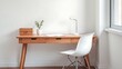 © mingfu - Minimalist office corner with wooden desk and white chair, featuring a potted plant and natural light.