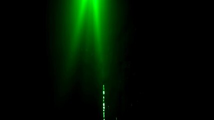 Wall Mural - Intense green light beams create a dramatic, abstract scene in the darkness with a subtle light trail.