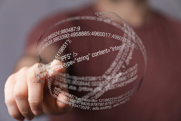 a hand interacts with a digital sphere of code representing the internet, showcasing the concept of 