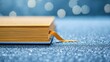 © MAY - Gold bookmark placed elegantly in a journal, offering a stylish touch to the personal space.