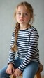 © natakot - Thoughtful young girl with braided hair in a striped shirt
