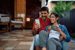 © Drazen - Happy couple using smart phone while enjoying in afternoon on their porch.