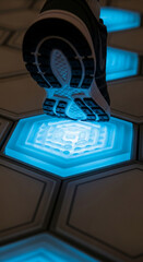 Wall Mural - close-up of shoe sole on glowing hexagonal floor tile, showcasing futuristic technology interaction,