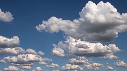 Wall Mural - Watch a breathtaking 4K time lapse video where the endless summer sky transforms with layers of soft cumulus clouds floating slowly across a vibrant azure background perfect for relaxation and