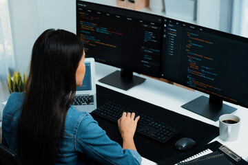 Wall Mural - young asian in it developer creating with typing online information on pc with coding program data o