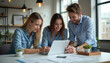 © AlexanderVP - Three young professionals collaborating on a laptop in a modern office
