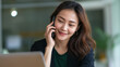 © Kateryna - Young Asian businesswoman on video call in office setting