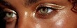 © Iurii - Side-angle view of glowing highlight on tanned skin with gold sheen detail