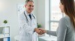 © sujon1638 - Friendly doctor greets patient with a warm handshake in a bright modern medical office setting