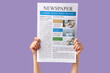 © Pixel-Shot - Female hands with newspaper on lilac background