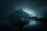Misty mountain range reflecting in dark water, village lights twinkling