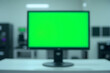© Aldy - Computer Monitor Displaying Green Screen on Desk in Office Setting