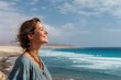 © LimeSky - Joyful woman gazing into the distance on a beach in Fuerteventura Spain