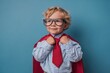 © LimeSky - Young superhero student in uniform Joyful kid with glasses prepared for learning Success and motivation theme Back to school Young businessman hero