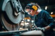 © LimeSky - Woman worker at lumber factory using saw