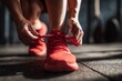 © Diamond Studio  - Close-up of a sportswoman tying her shoes, preparing for a morning workout at a gym in the city.