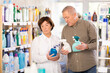 © JackF - Couple elderly man and woman buyers choosing cleaning spray in household chemicals store