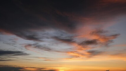 Wall Mural - a sunrise sky time-lapse highlighting nature’s grace, as golden sunlight streams through layers of c