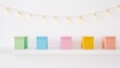 © maria - Pastel minimalist storage boxes neatly arranged on a white shelf with delicate fairy lights, creating a soft and organized aesthetic against a clean white background with ample copy space