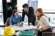 © Jack Tamrong - Male Indian real estate project manager working and brainstorming with female architect teammates